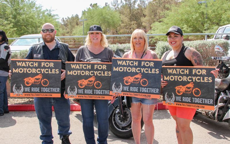 watch for motorcycles group A group holds signs that say watch for motorcycles